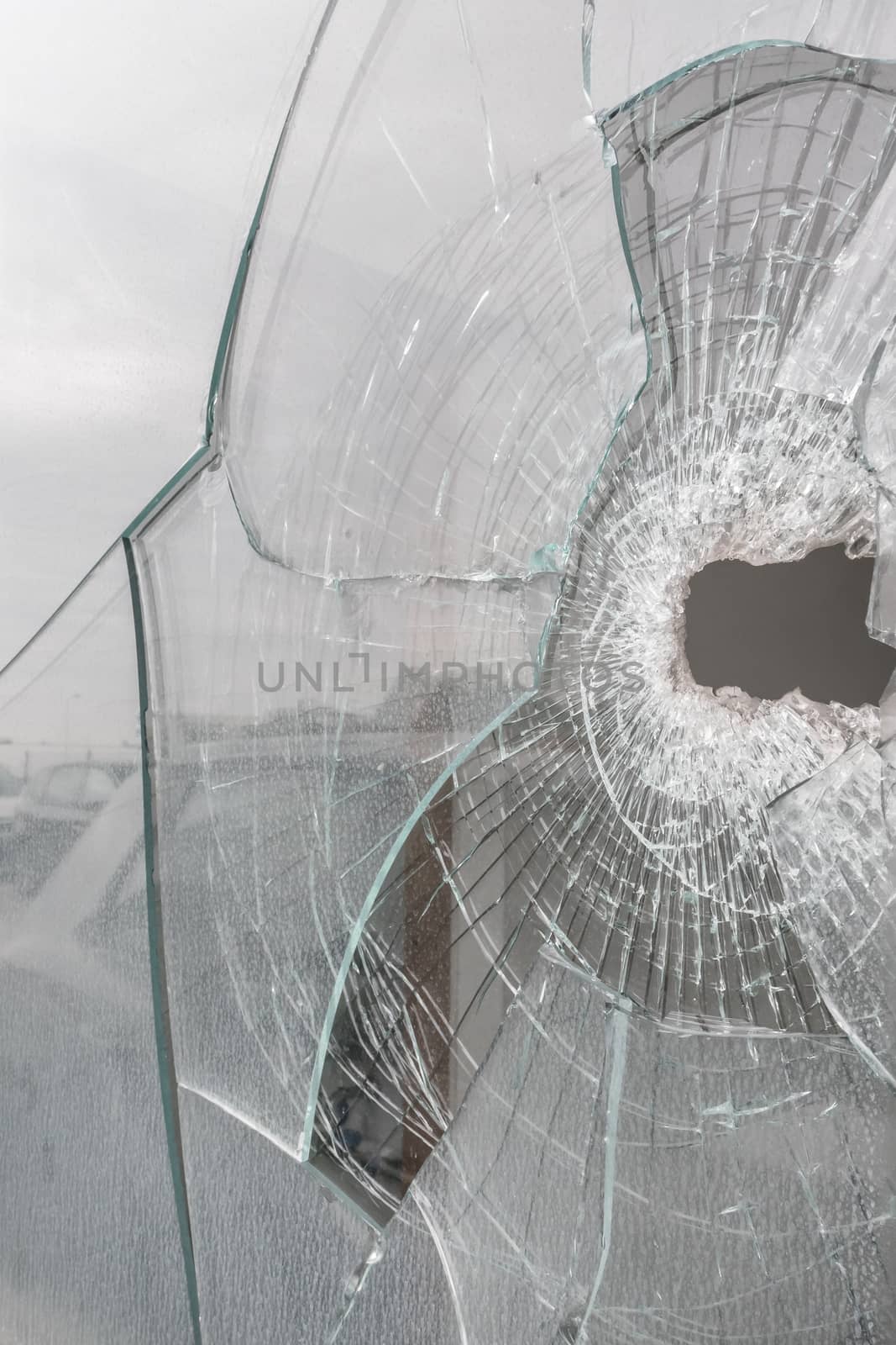 Glass broken with hole and splinters. Ideal for backgrounds and concepts.