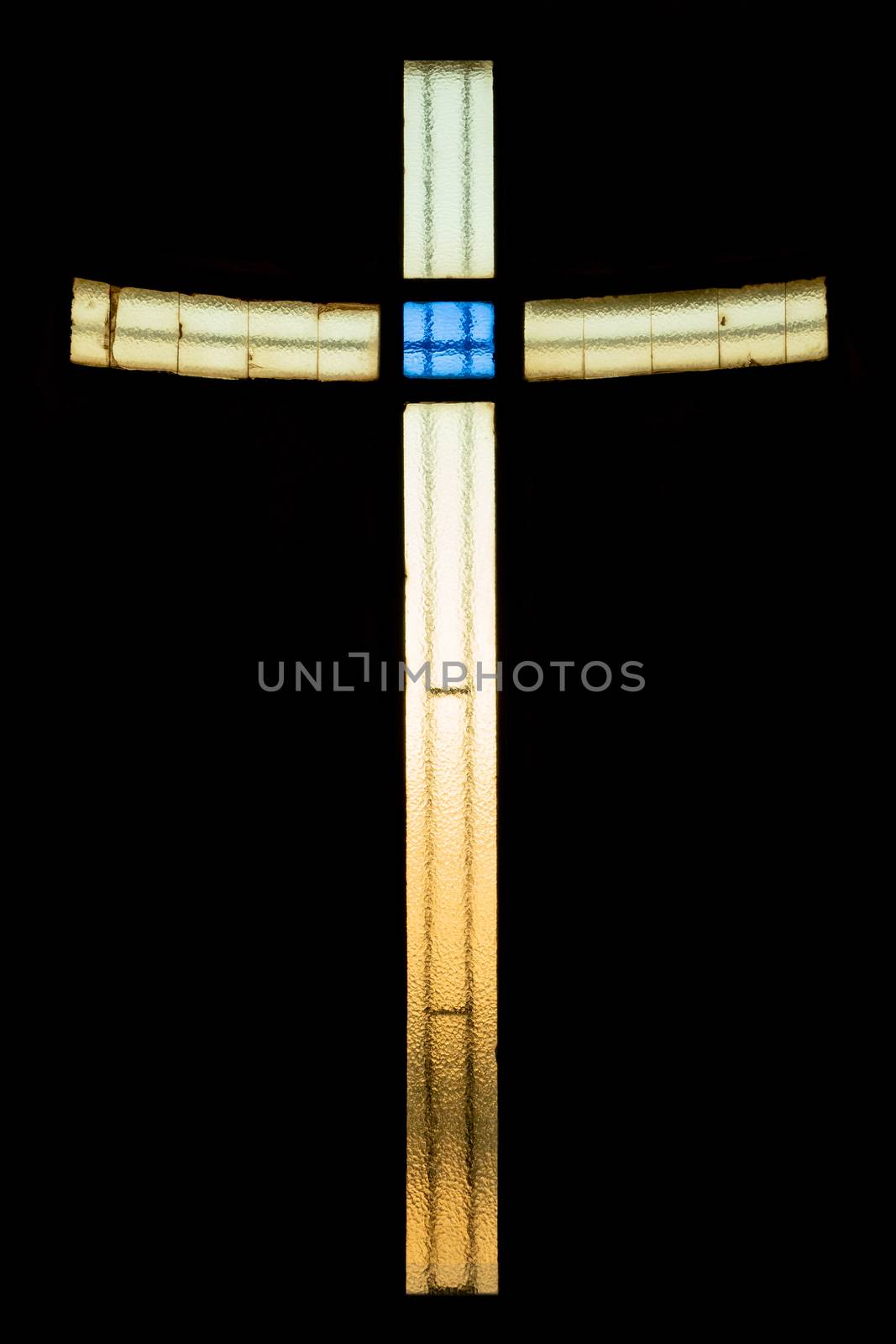 Stained glass cross in bright vivid colors in a church. Ideal for events, concepts and backgrounds.
