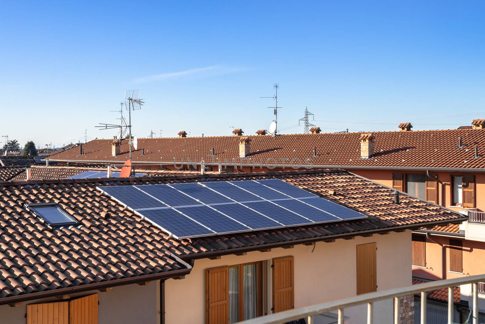 Solar panels on suburban Italian home. Photovoltaic power plant. Regenerative energy system electricity generation.