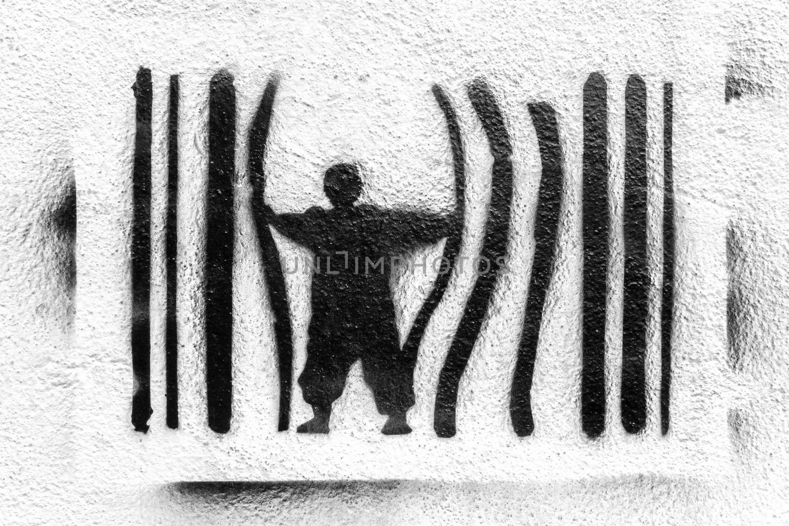 Graffiti depicting a man escaping from prison. Concept of escape, protest against the system. Power and control.