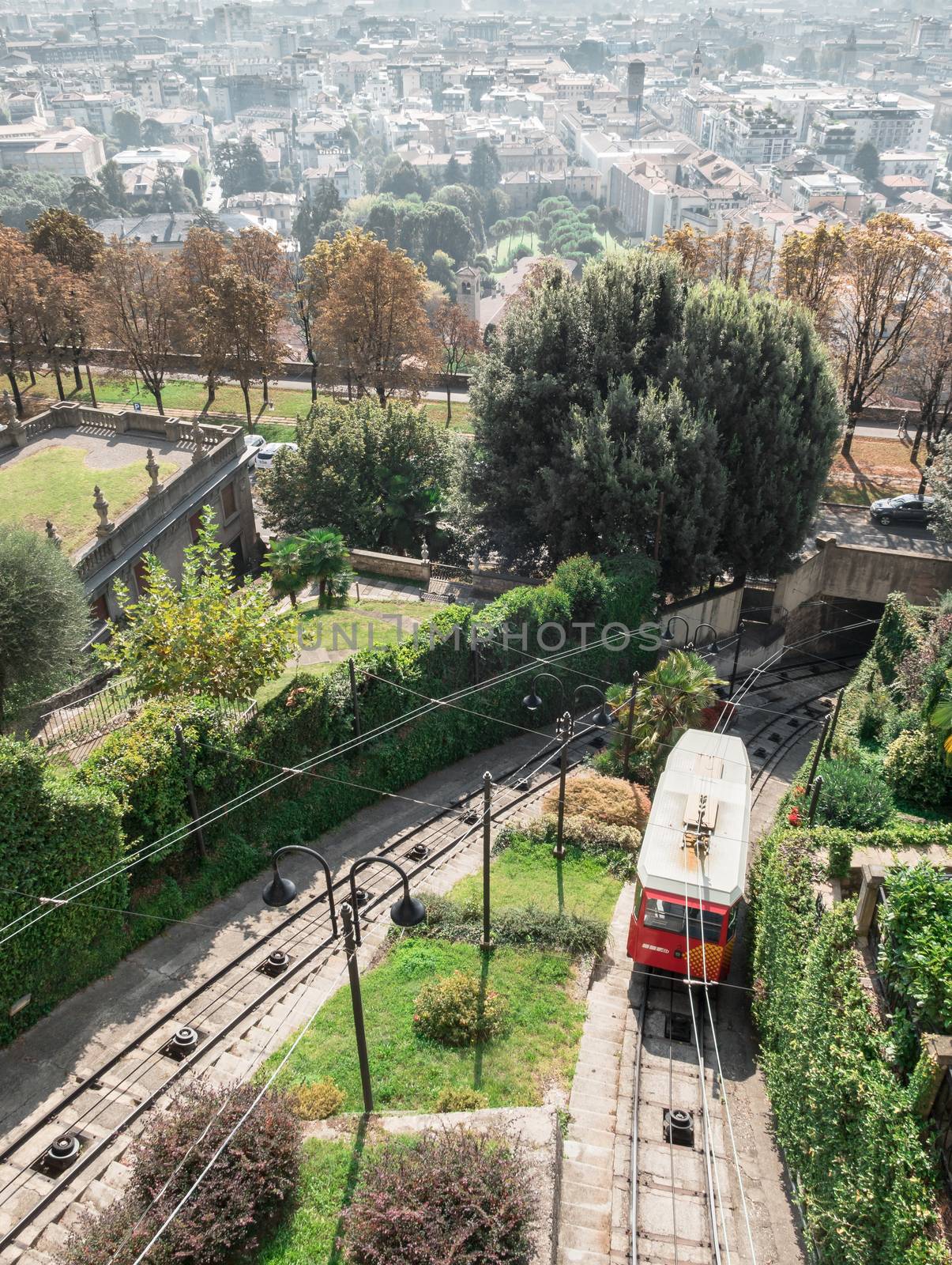 Upper city funicular line in Bergamo (Funicolare Citta Alta). Red funicular connects old Upper City and new. Scenic view of Bergamo historical center. Bergamo (upper town), ITALY - October 5, 2019