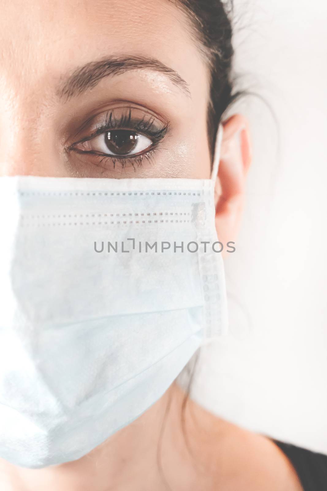 Medical mask on woman face by germanopoli