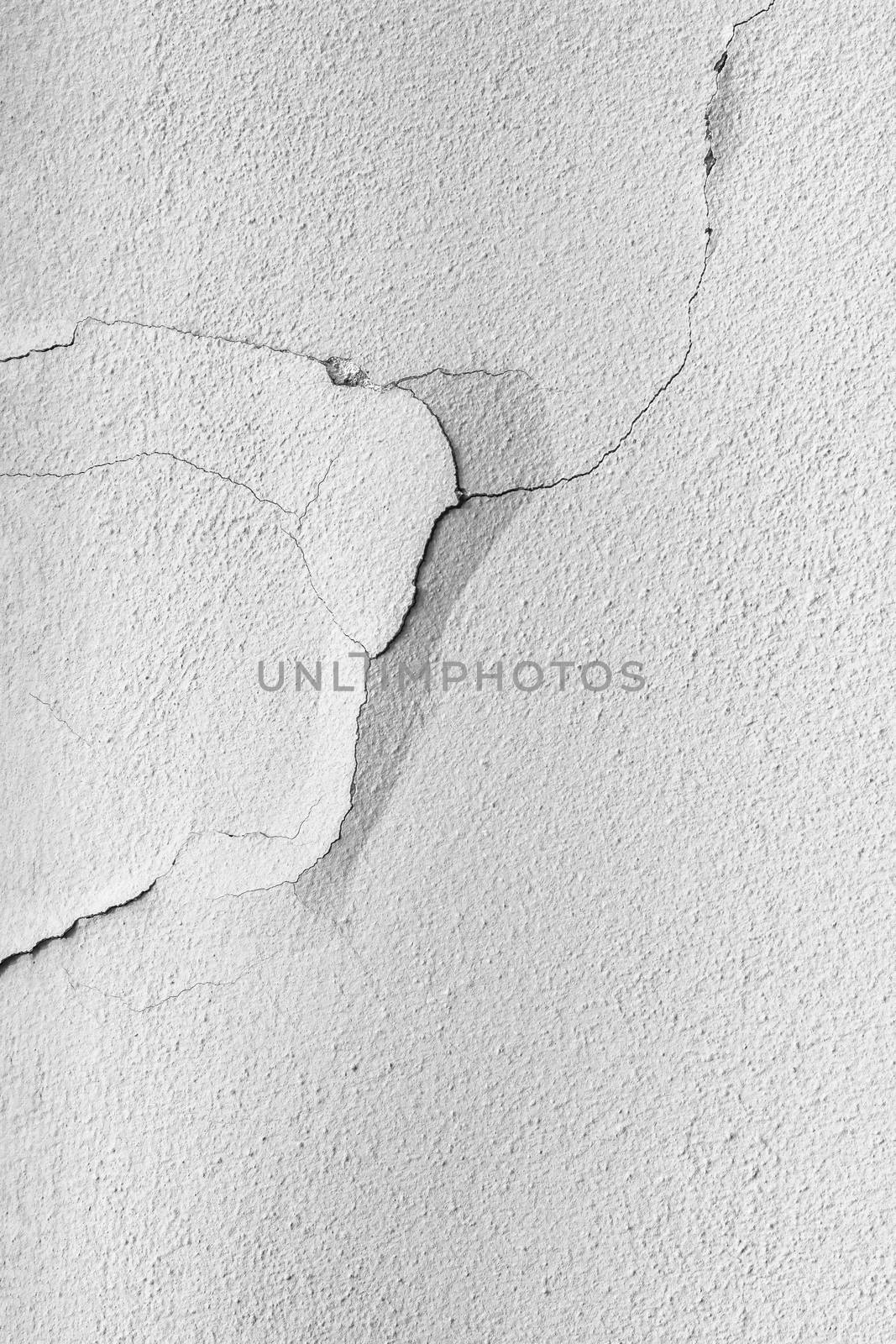 Crack in the wall. Peeling painted wall. Texture grunge background. Cracked paint with gray wall.