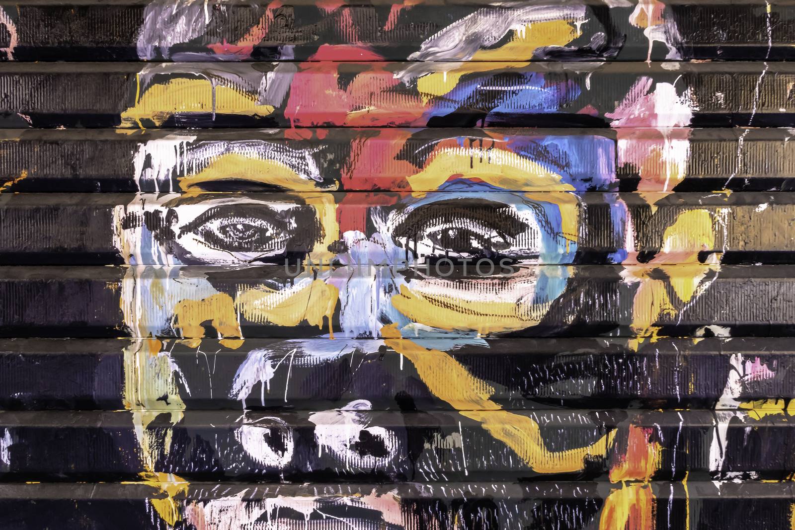 Colorful human face on graffiti artwork by germanopoli