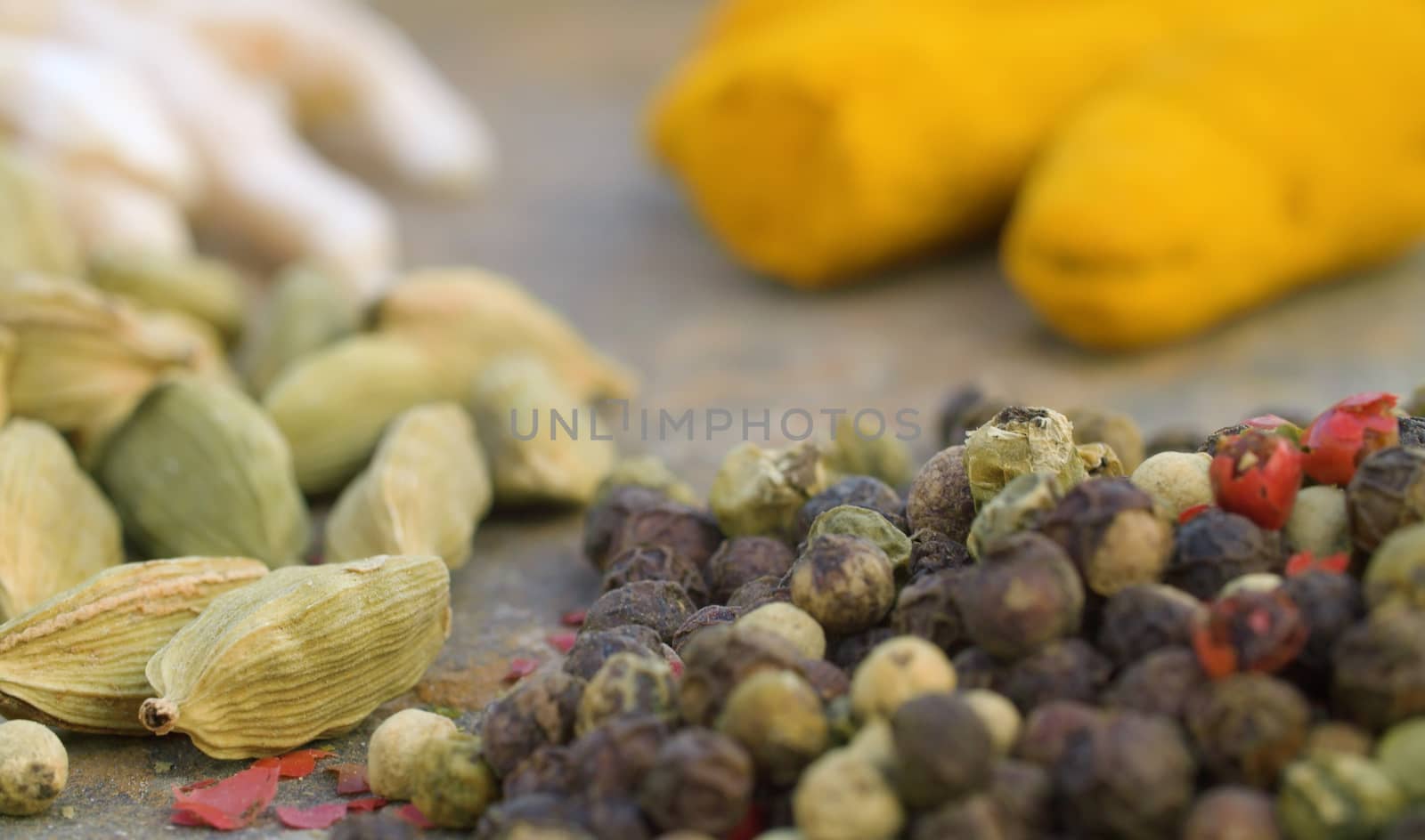 Macro shot spices on the table. Pepper, cardamom, turmeric. Extreme close up