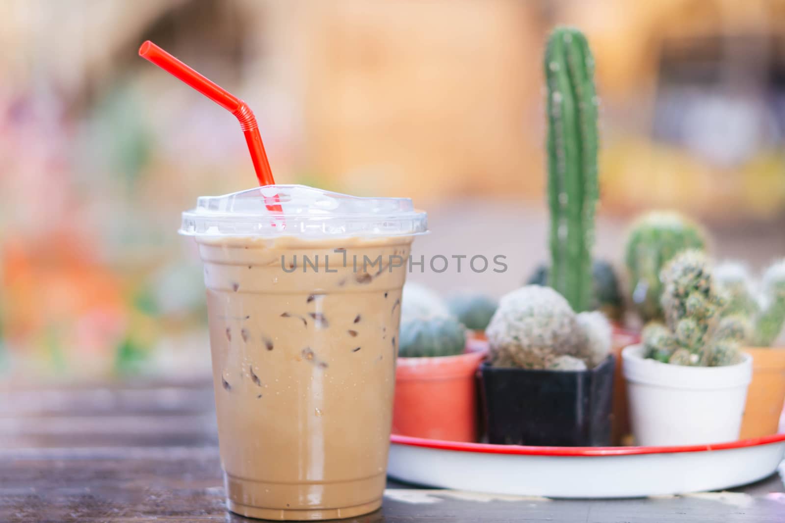 Close up glass of ice cappuccino coffee on wood table  background, selective focus