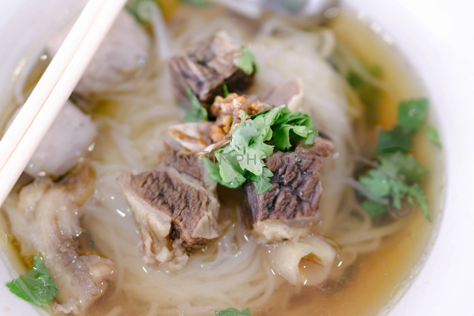 Rice noodle soup with Cooked Liver in  bowl on table, selective focus