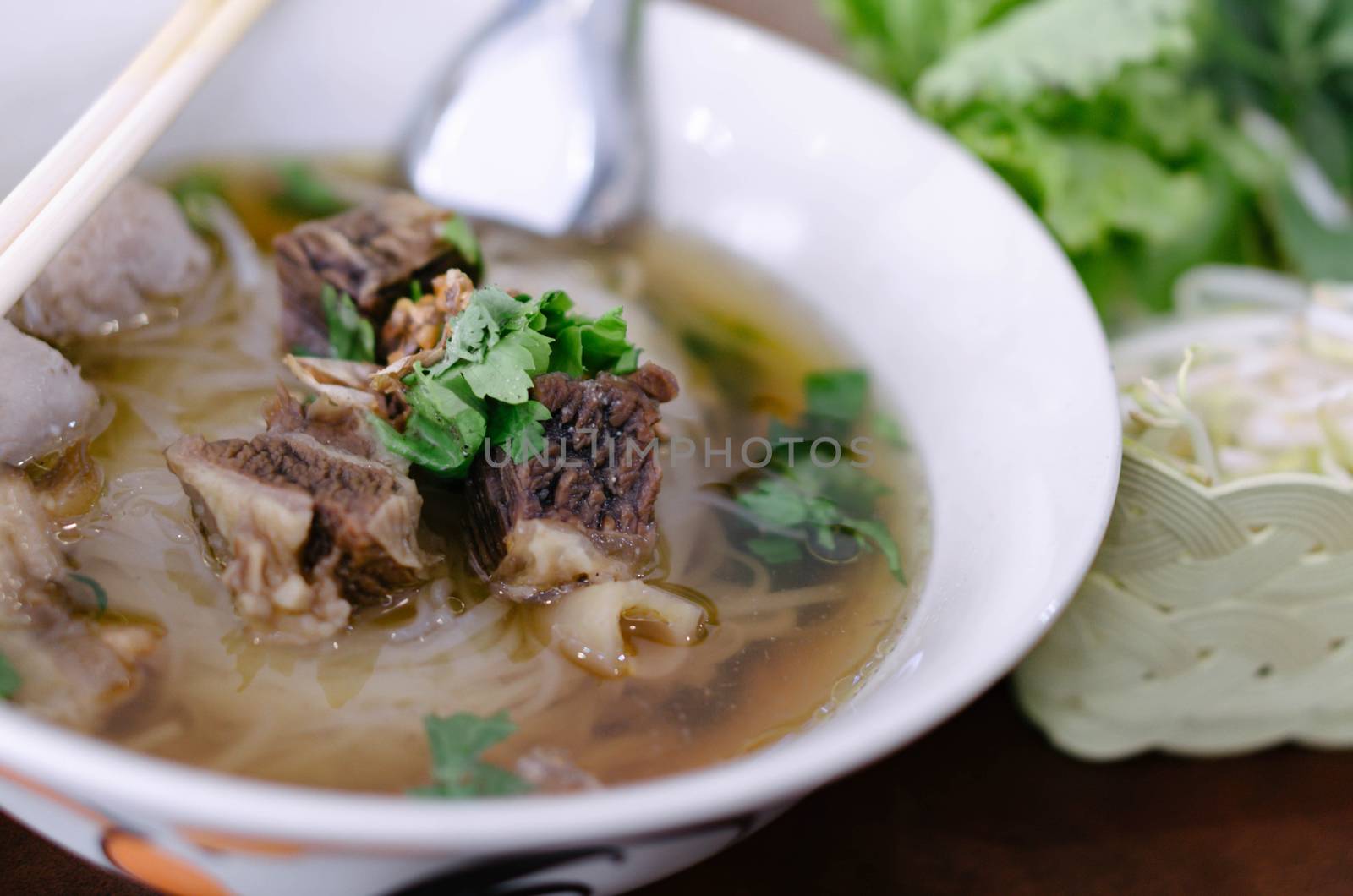 Rice noodle soup with Cooked Liver in  bowl on table, selective focus