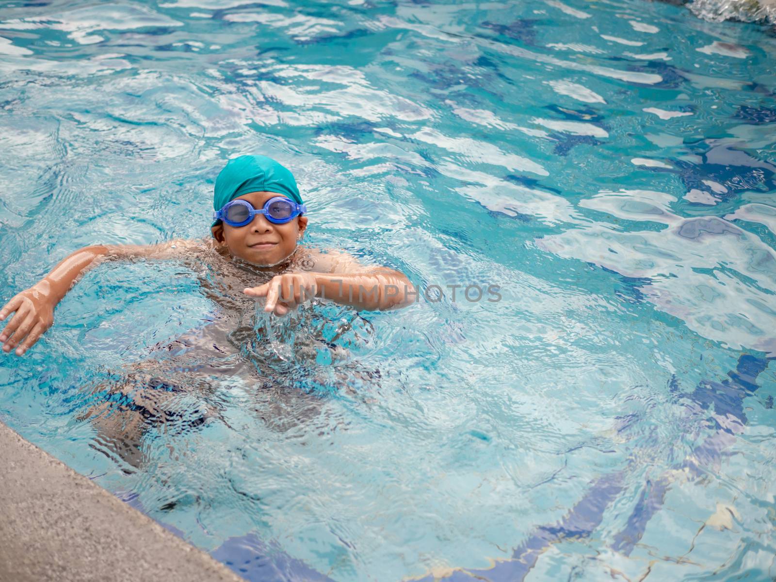 A boy swimming in the pool
