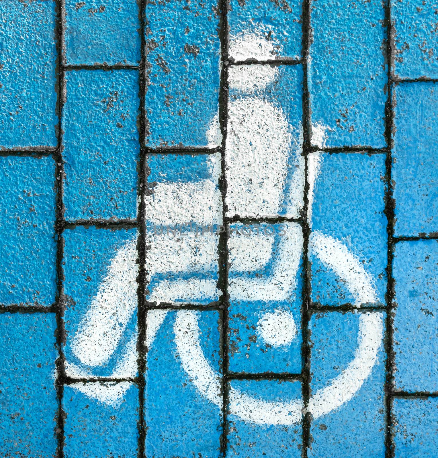 International handicapped (wheelchair) or Disabled parking symbol. Handicapped parking sign on the ground. Wheelchair symbol. White and blue parking lot paint. Special place for disabled.