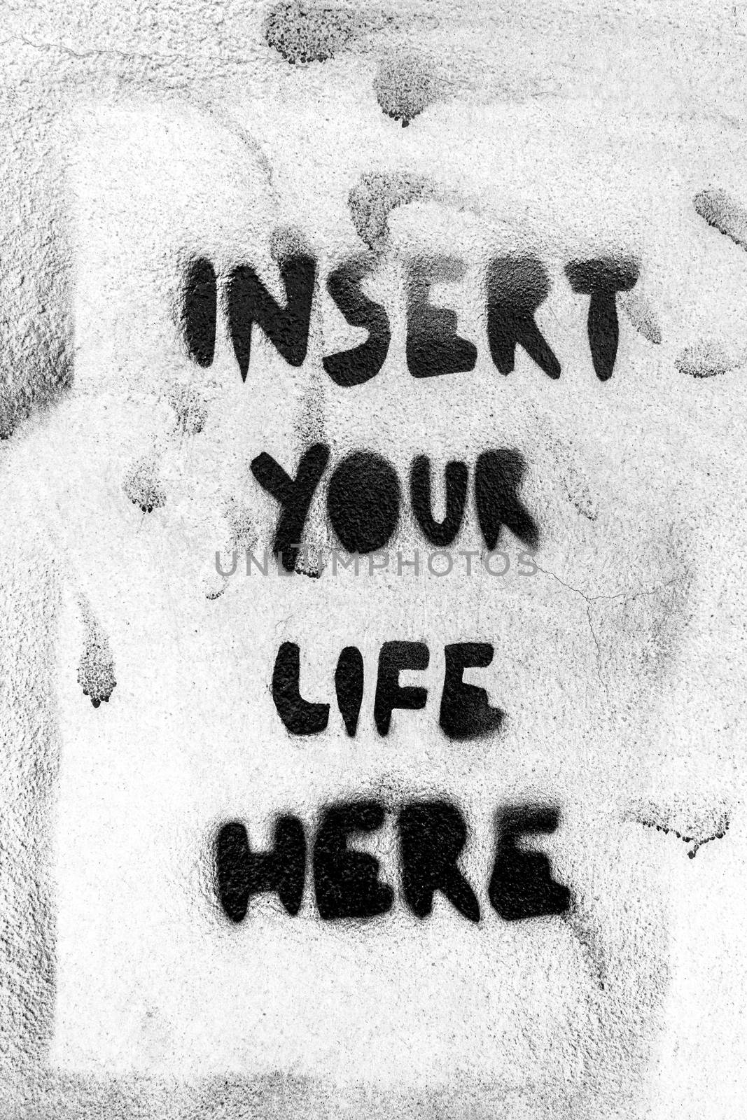 Message "Insert your life here" on wall with grungy frame. Grunge wall background. Ideal for concepts. It can be used as a urban theme, poster, wallpaper, design t-shirts and more.