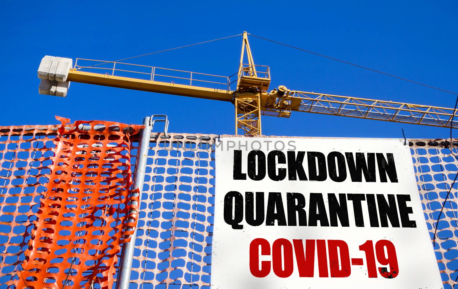 Billboard on the construction site with message LOCKDOWN QUARANTINE COVID-19. COVID-19 alert concept. Lockdown. Concept of stop working activities due to coronavirus medical emergency.