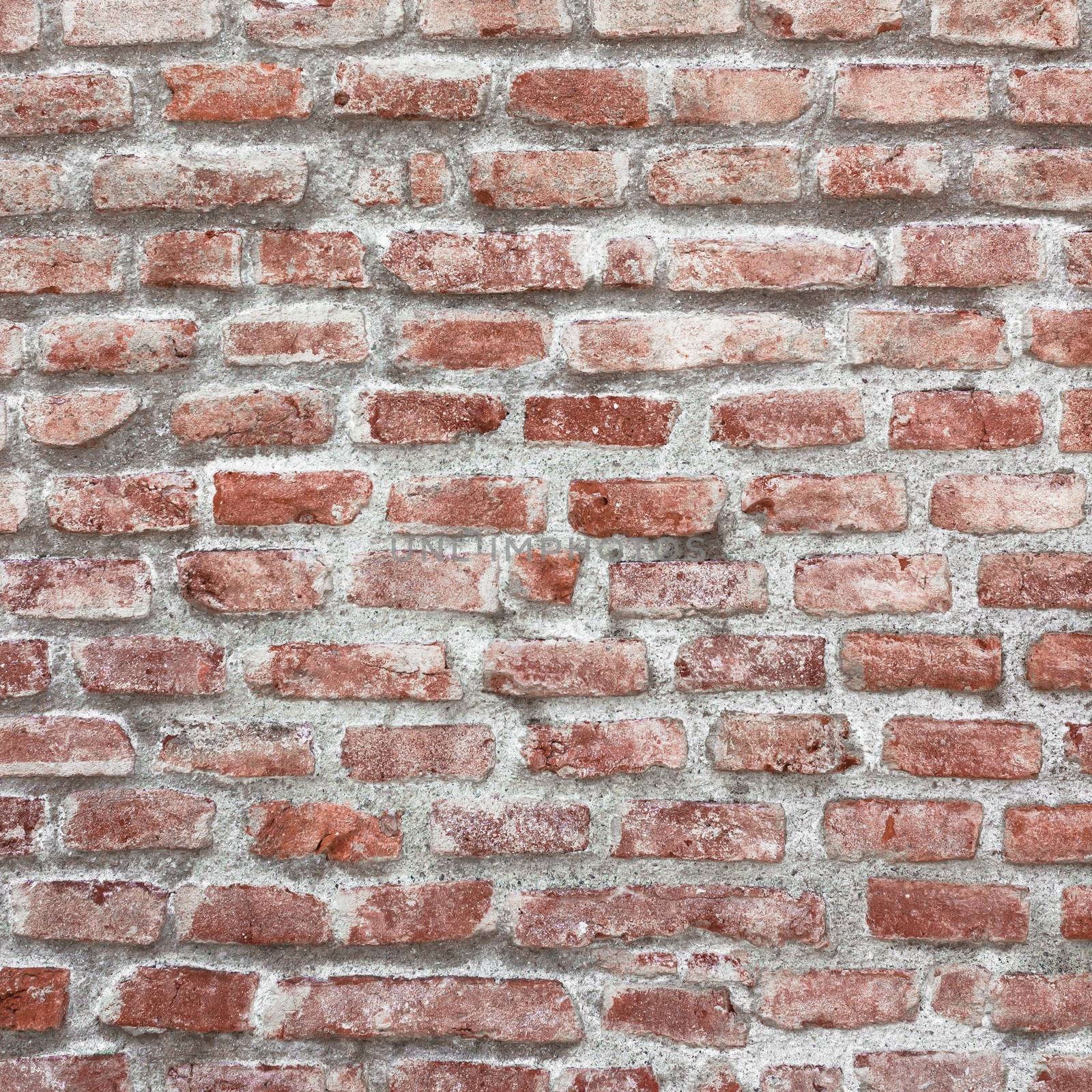 Ancient stone masonry. Fragment of a brick wall of an ancient structure. Exterior decoration of the building. A background for design and creative work.