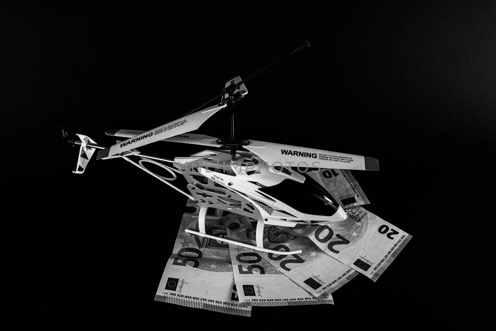 terni,italy august 21 2020 : model helicopter on top of euro banknotes of different denominations