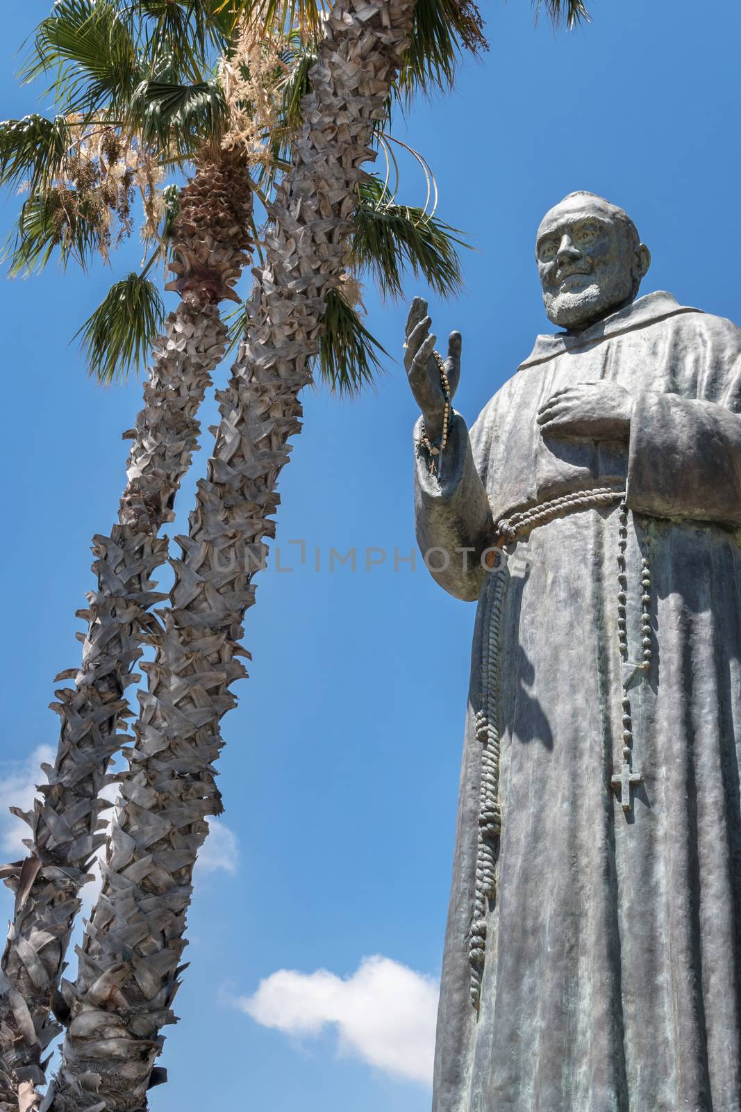 Statue of Saint Father Pio on sky background. Ideal for concepts or events.