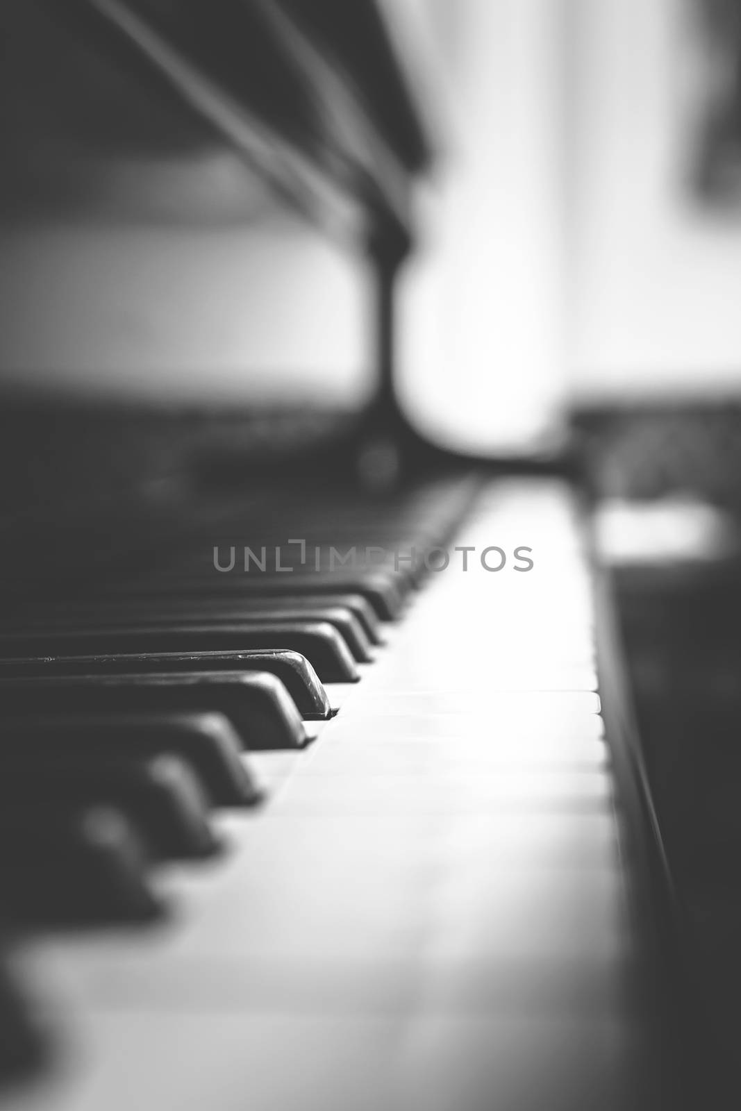 Extreme closeup of piano keyboard. Shallow DOF. Retro style photo.