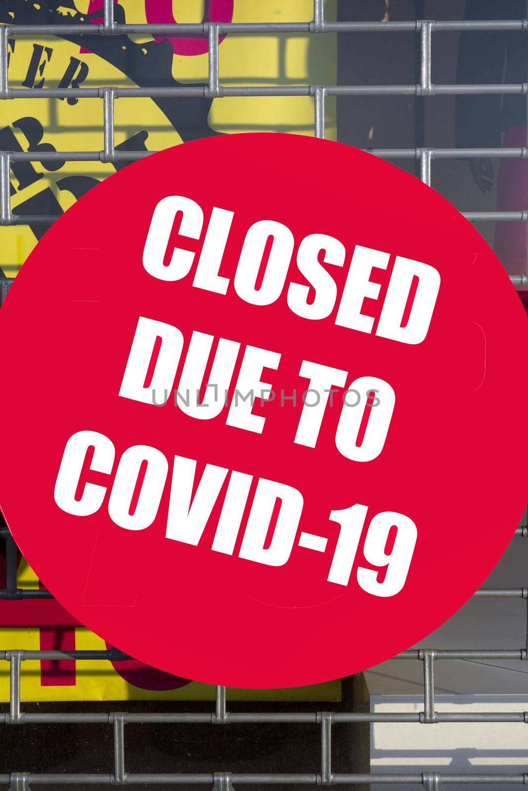 Shop for quarantine for COVID-19. Store closure under COVID-19 global pandemic. Closed wire mesh door front. Small business store closed due to Coronavirus.
