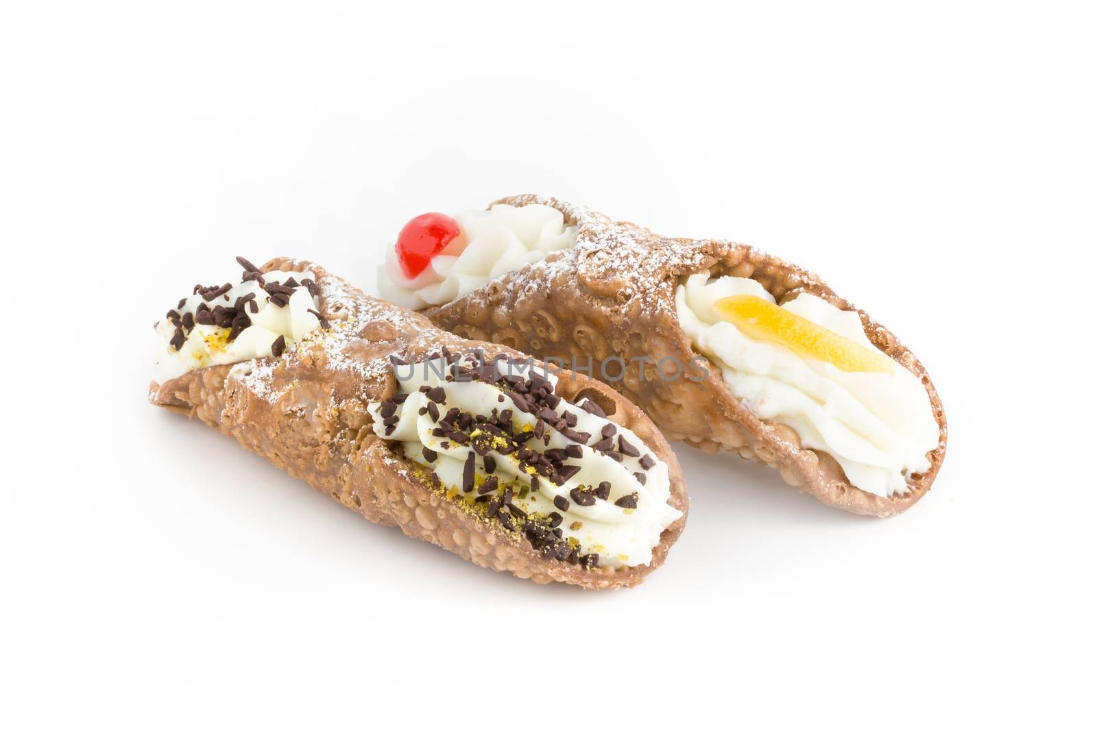 Sweet homemade cannoli stuffed with ricotta cheese cream, candied fruit, chocolate flakes and pistachio. Typical Sicilian dessert. Italian pastry.