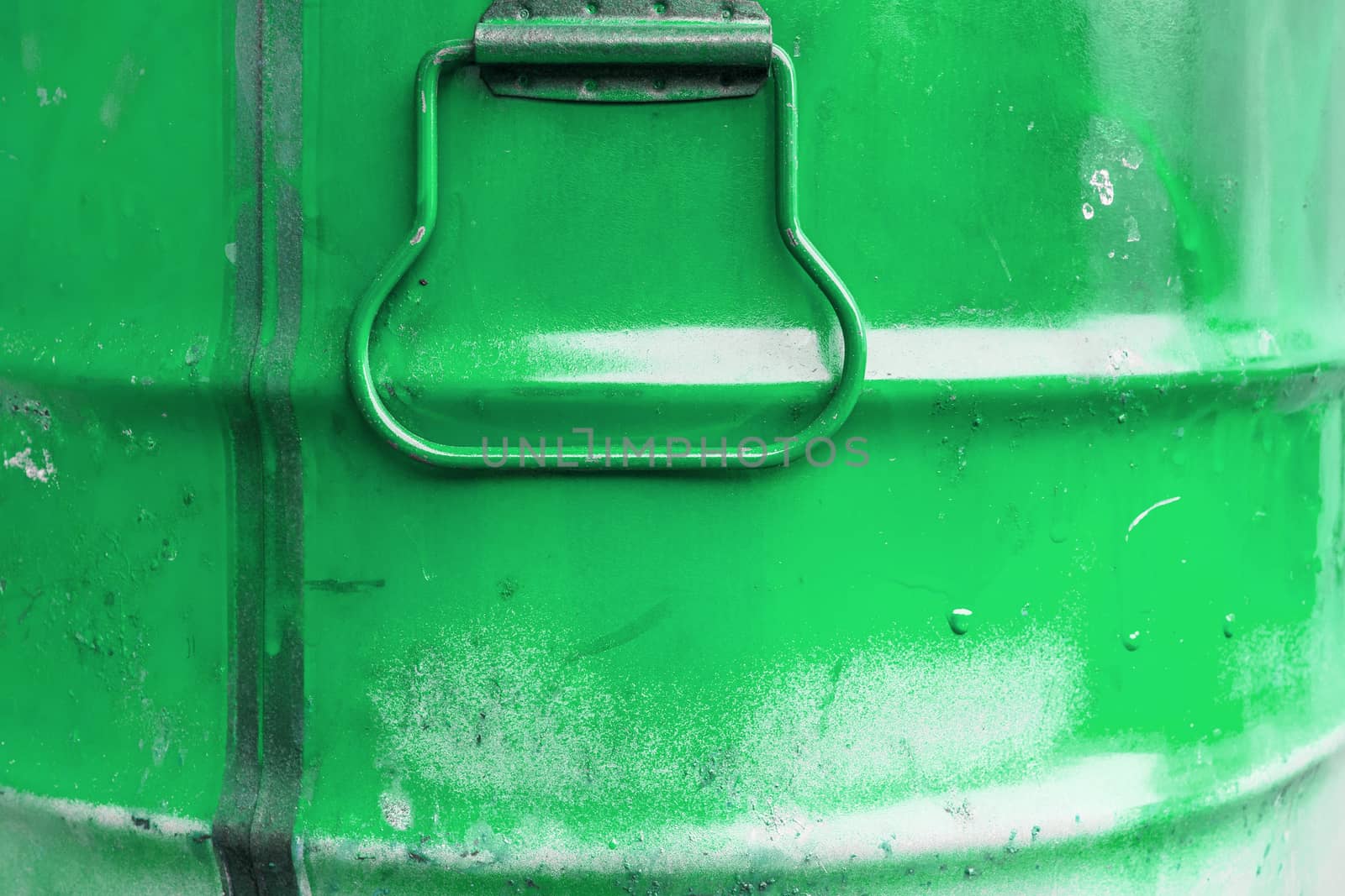 Green color can. Metal can with green paint drips.