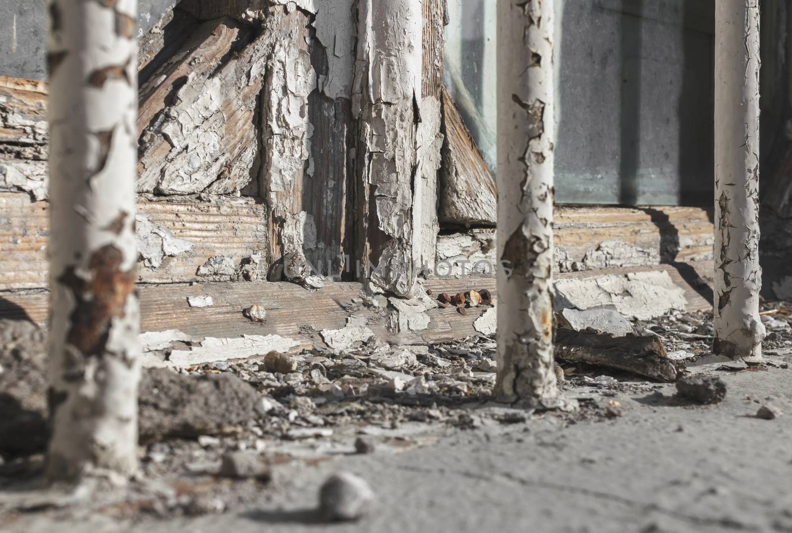 Old wooden glazed window frame with peeling paint. Empty wooden window frame and chipped wall texture. Window frame in dire need of maintenance.