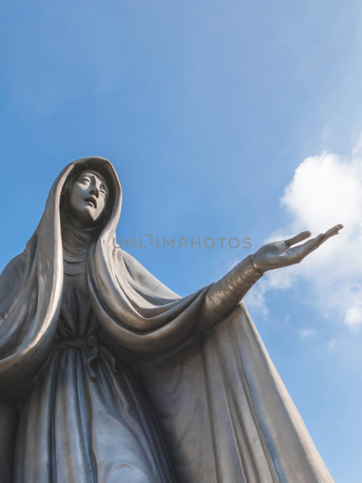 Statue of Virgin Mary. Our Lady of Fatima. Copy space on sky.