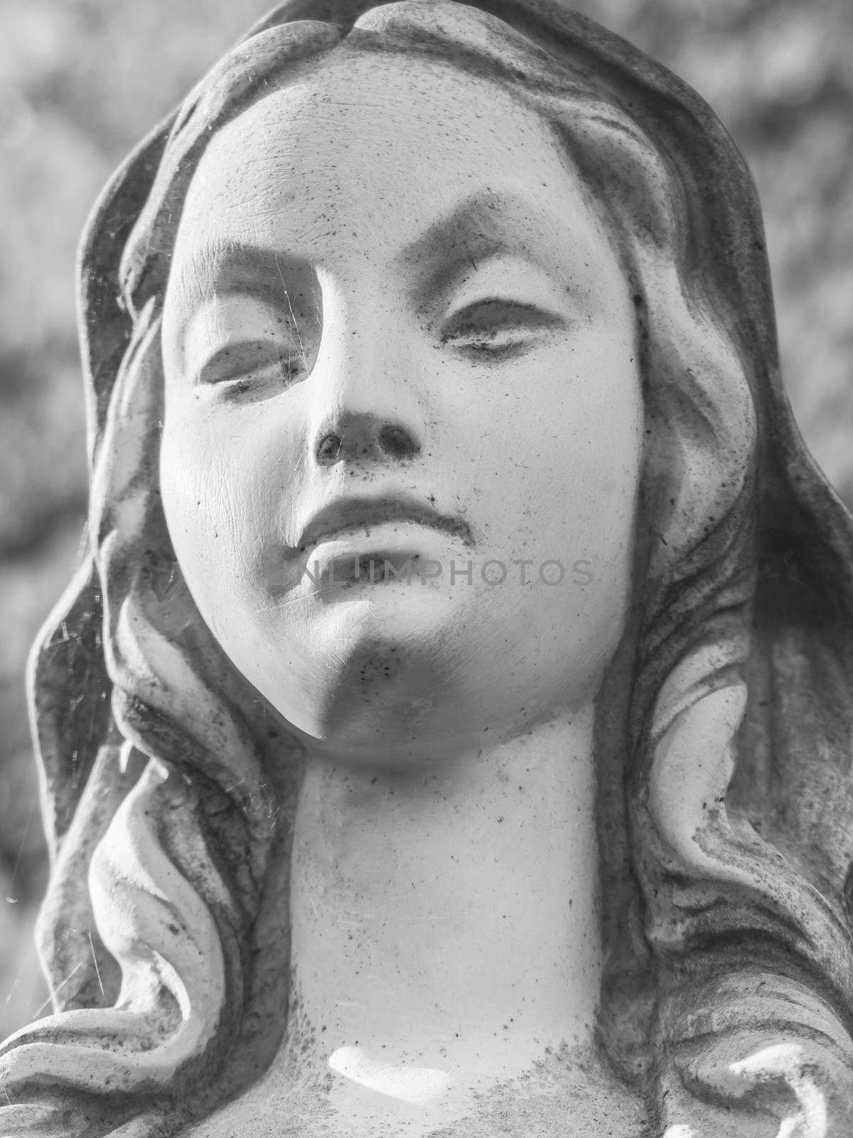 Female statue with angry face. Anger, resentment, negative emotions. Retro style photo.