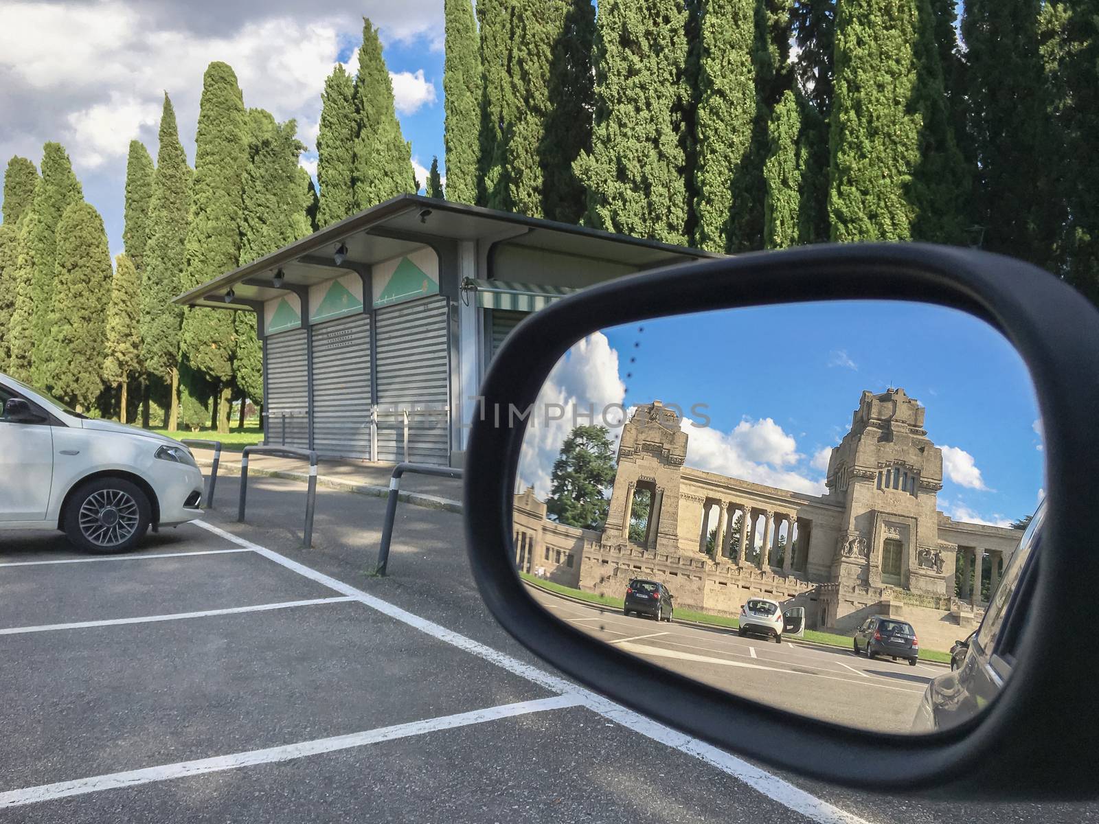 The cemetery of Bergamo reflected in the rearview mirror by germanopoli