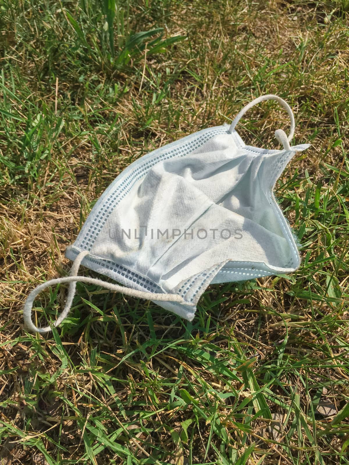 Medical protective mask thrown to the ground by germanopoli