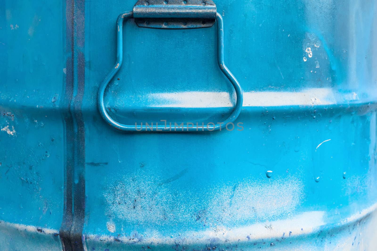 Blue color can. Metal can with blue paint drips.