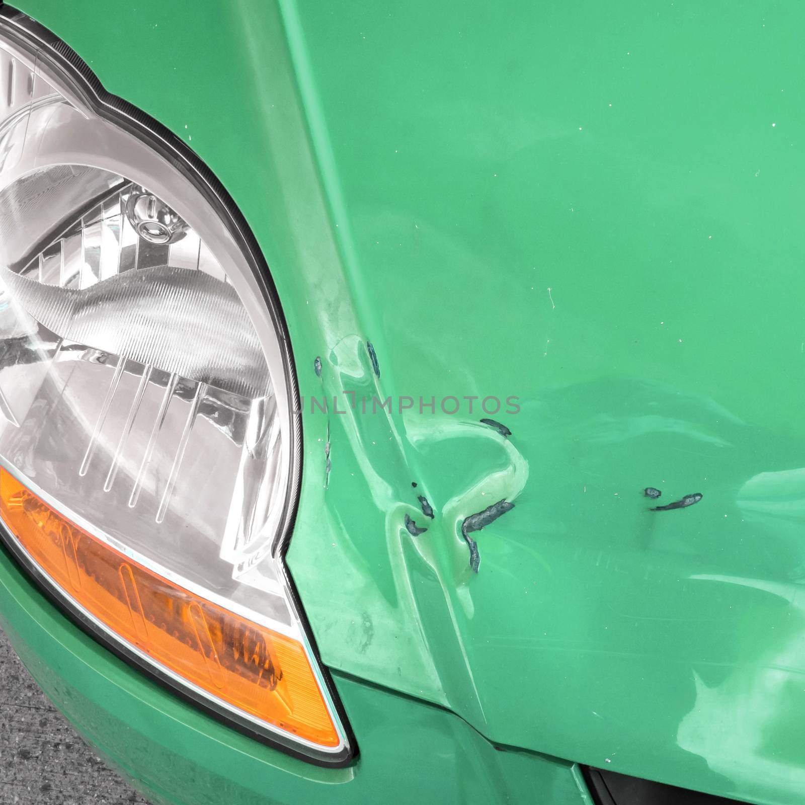 Damaged bodywork. Dents and scratch marks on a car's hood. Close-up.
