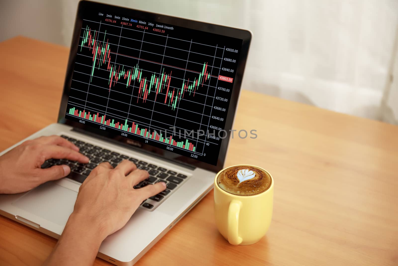Business and technology concept Businessman hands with laptop and candlestick chart background. Businessman hands use computer network control trade buy and sell stock market with copy space.