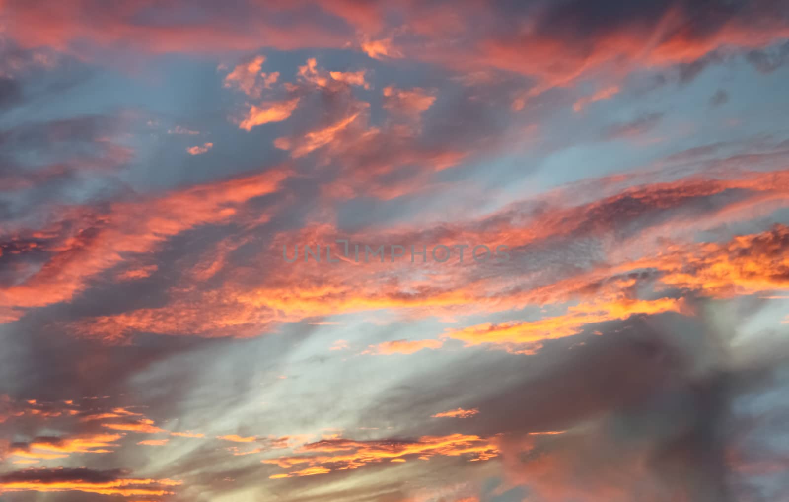 Beautiful panorama of orange and yellow clouds at sunrise and sunset in a blue sky