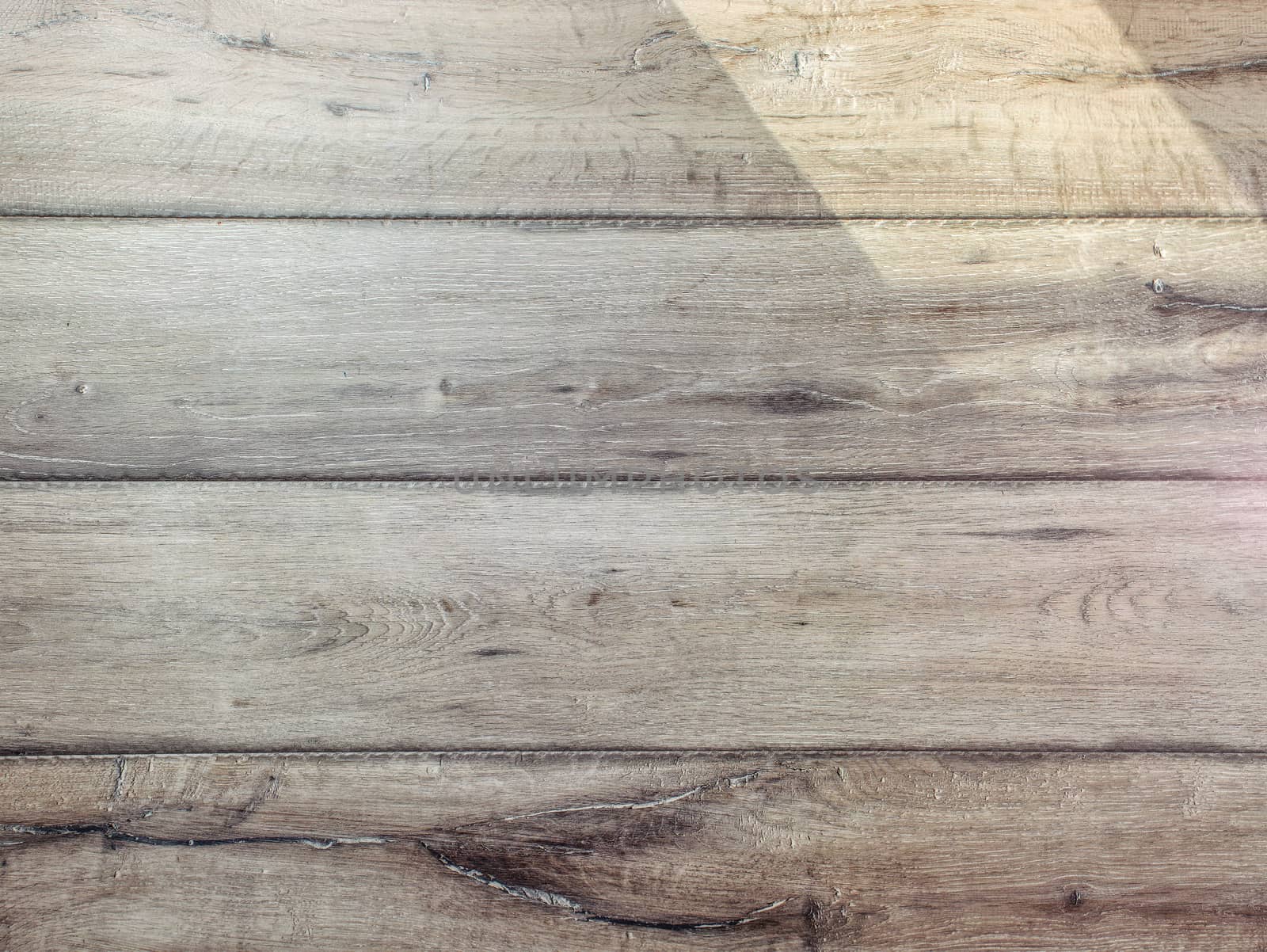 Texture of gray wood floor lit by sun