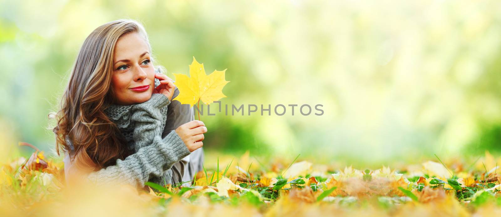 woman portrait in autumn leaf close up