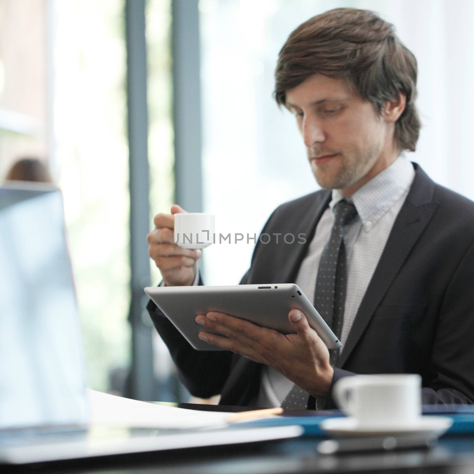 Business man with tablet computer in cafe