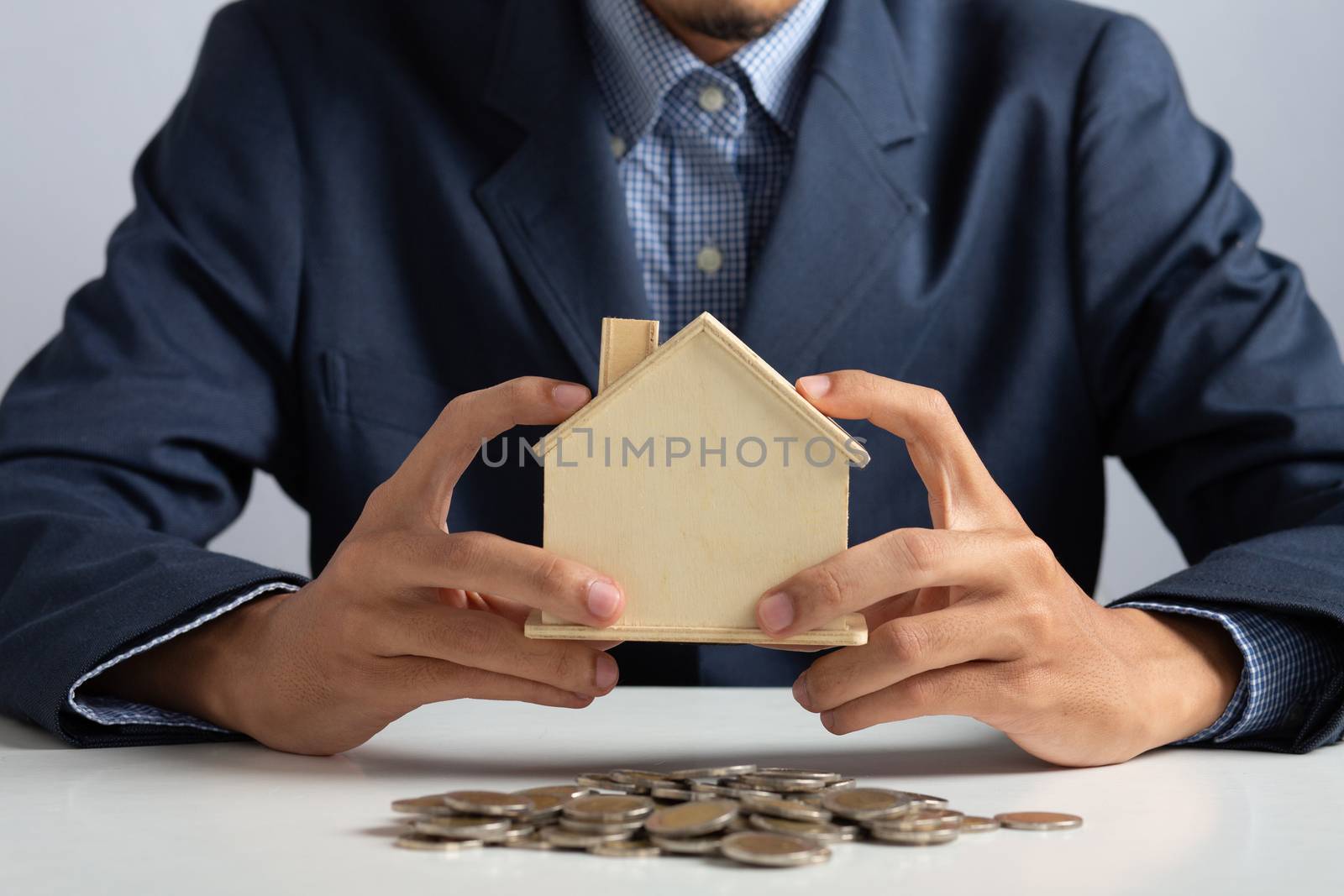 Hand of Business man holding coin put in piggy bank with money stack growing growth saving money, Concept invesment for financial freedom plan, business deposit to hope success