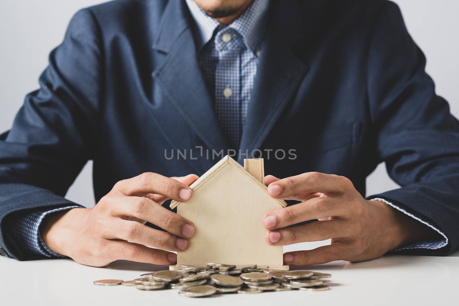 Hand of Business man holding coin put in piggy bank with money s by golfmhee