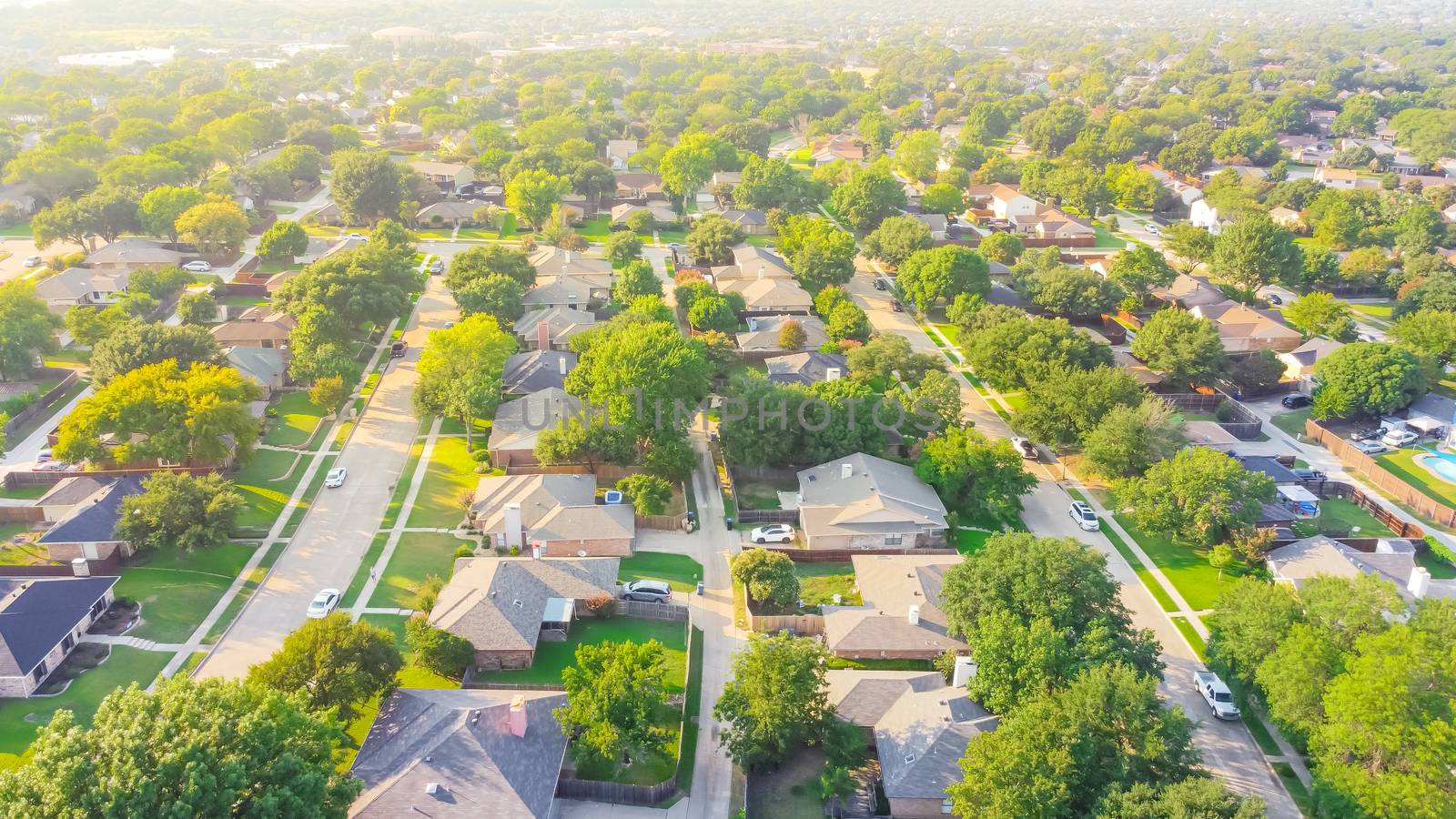 Bird eye view clean and peaceful neighborhood streets with row of single family homes near Dallas, Texas, USA by trongnguyen