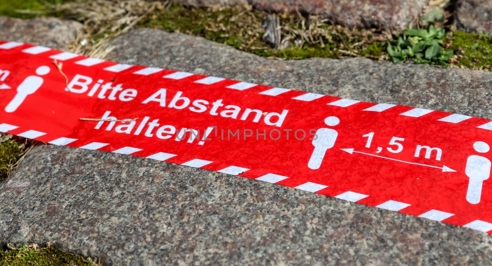 Bitte Abstand Halten! 1.5 meter social distancing sign for COVID-19. Keep distance symbol in german language