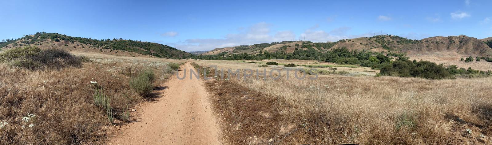 Panoramic view of small dry dusty trails in the valley by Bonandbon