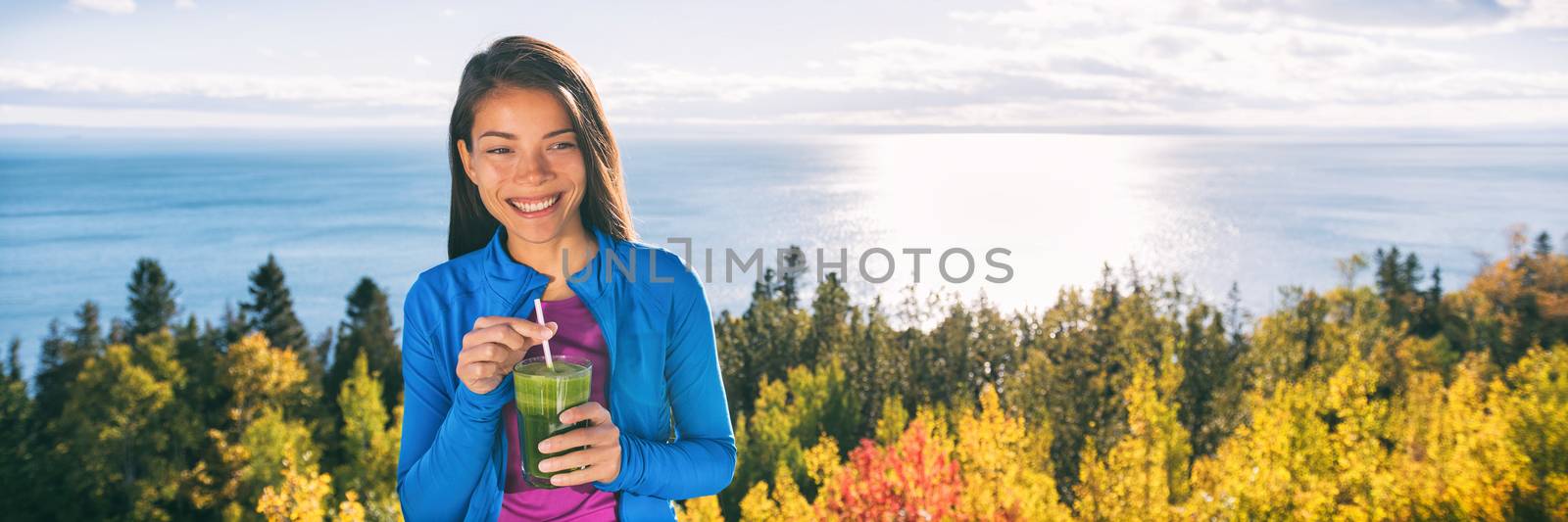 Healthy autumn woman drinking green smoothie glass by Maridav