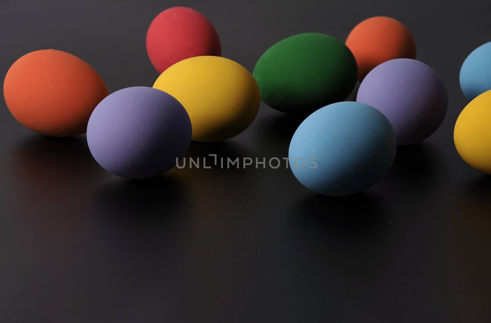 Multi-colorful of easter eggs on background in studio with close-up shot which include many colour such as yellow, green, blue, purple, red covered on eggs by art painting