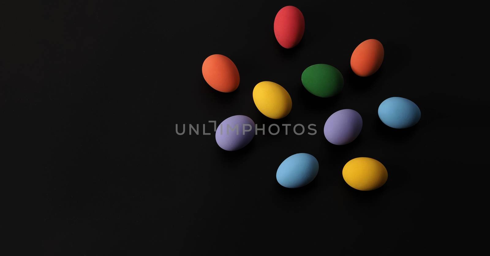 Multi-colorful of easter eggs on background in studio with close-up shot which include many colour such as yellow, green, blue, purple, red covered on eggs by art painting