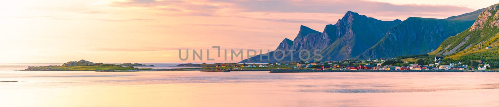 Landscape at sunset with beach and mountains. Purple sky in background. Travel in Norway, Scandinavia, Europe.