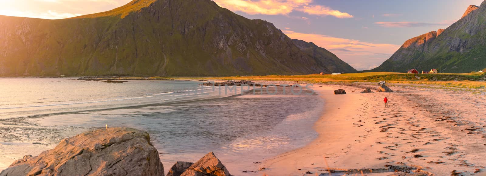Landscape at sunset with beach and mountains. Purple sky in background. Travel in Norway, Scandinavia, Europe.