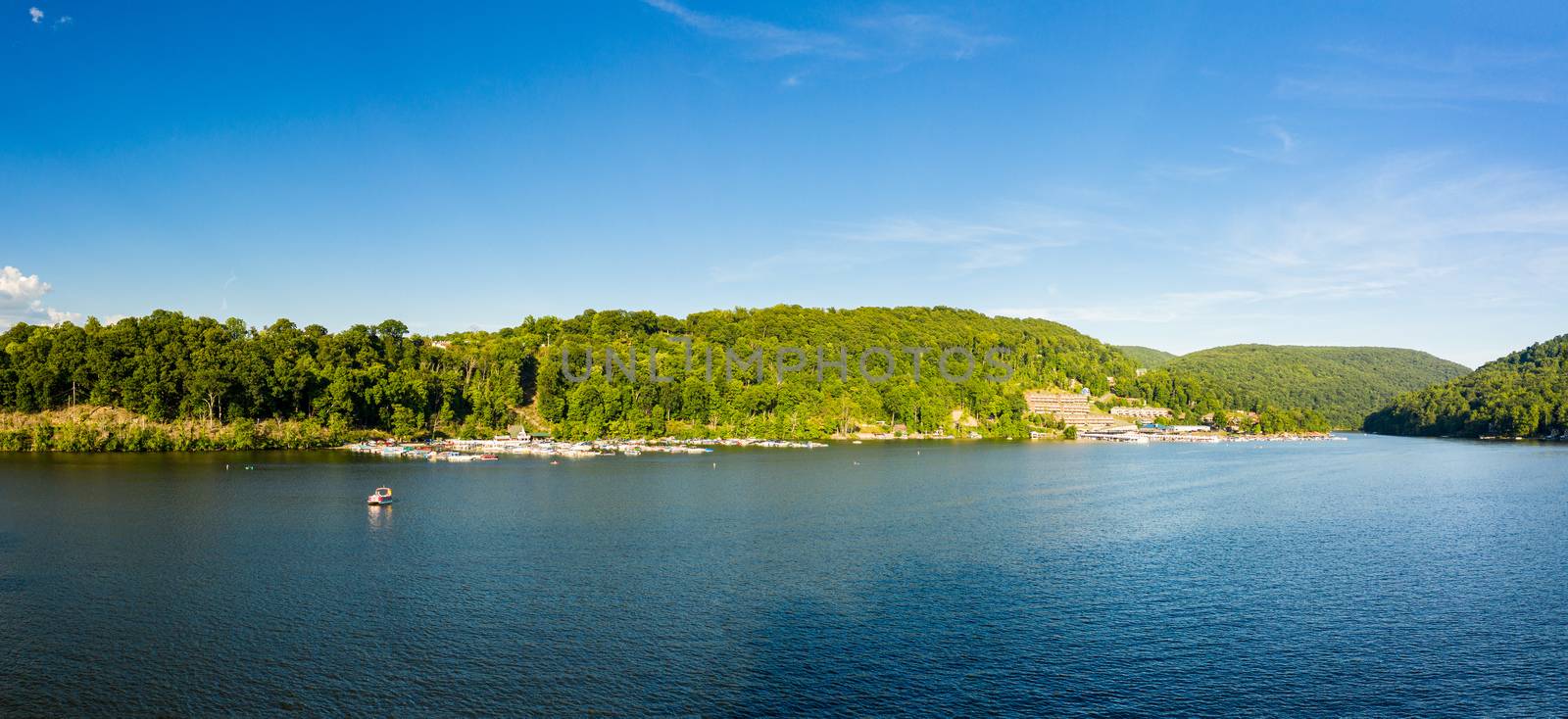 Wide panorama of Cheat Lake on a summer evening with boats docked in marina by steheap