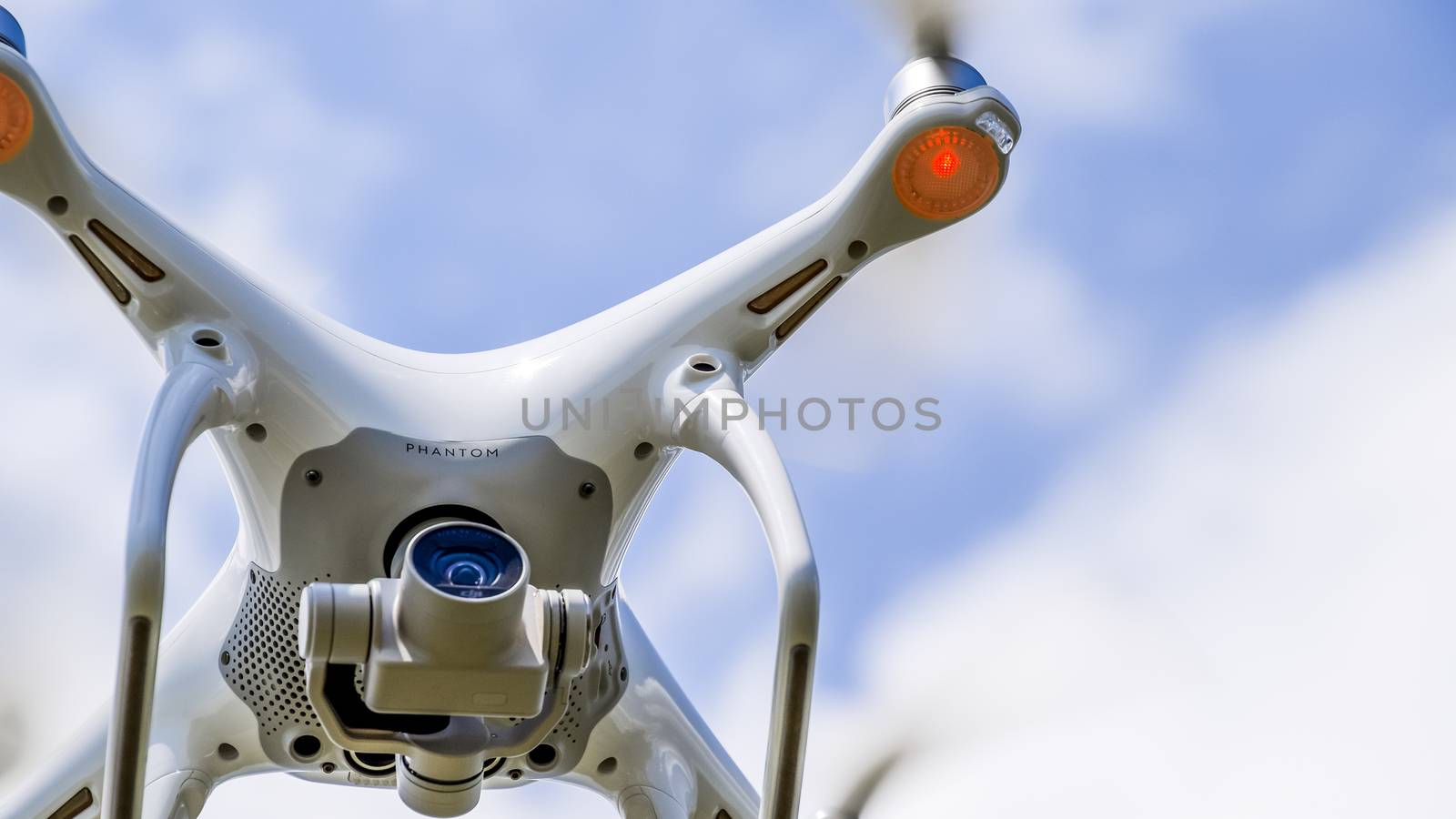 Krasnodar, Russia - May 30, 2017: Drone DJI Phantom 4 in flight. Quadrocopter against the blue sky with white clouds. The flight of the copter in the sky.