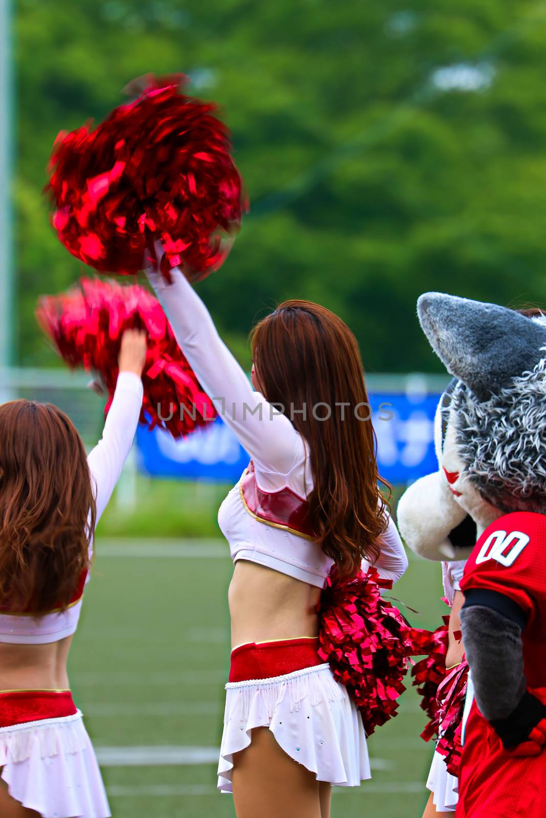 Watching a game Supporting scenery.Cheerleaders in Uniform Holding Pom-Poms. by USA-TARO