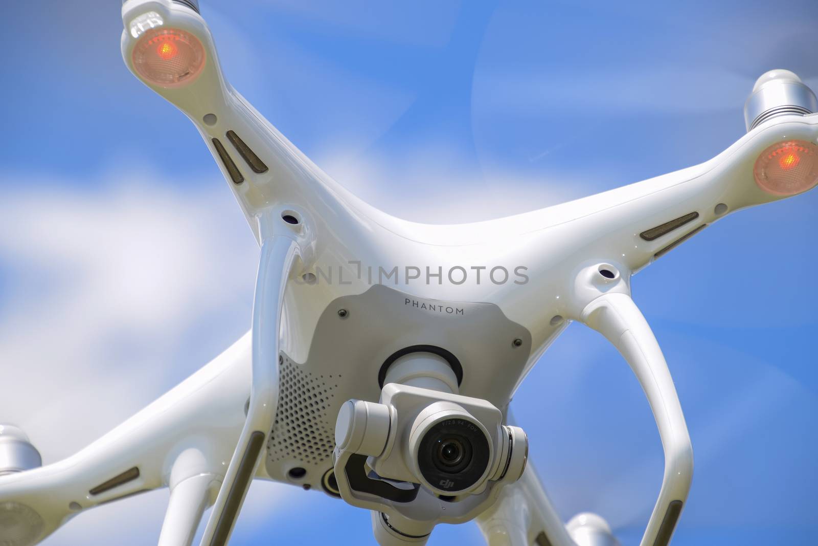 Krasnodar, Russia - May 30, 2017: Drone DJI Phantom 4 in flight. Quadrocopter against the blue sky with white clouds. The flight of the copter in the sky.