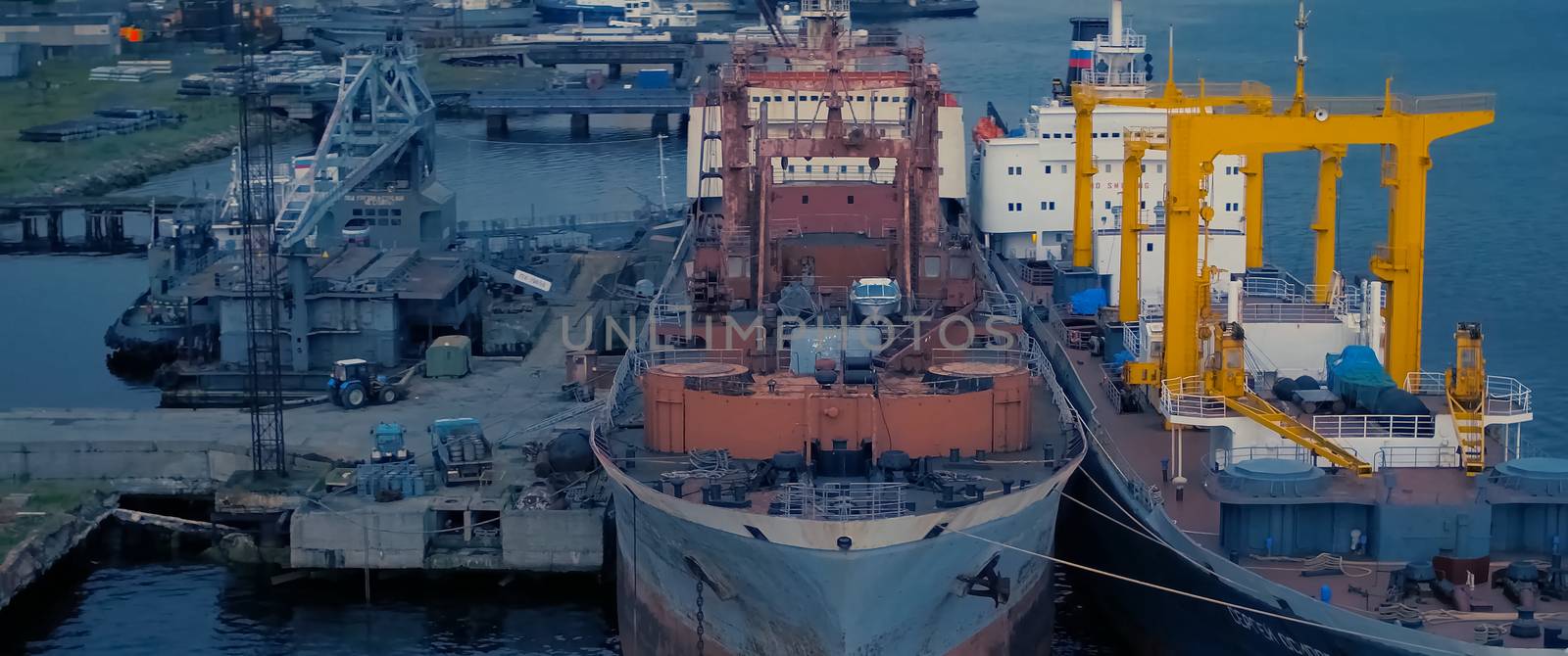 Auxiliary cargo ship in the industrial port.